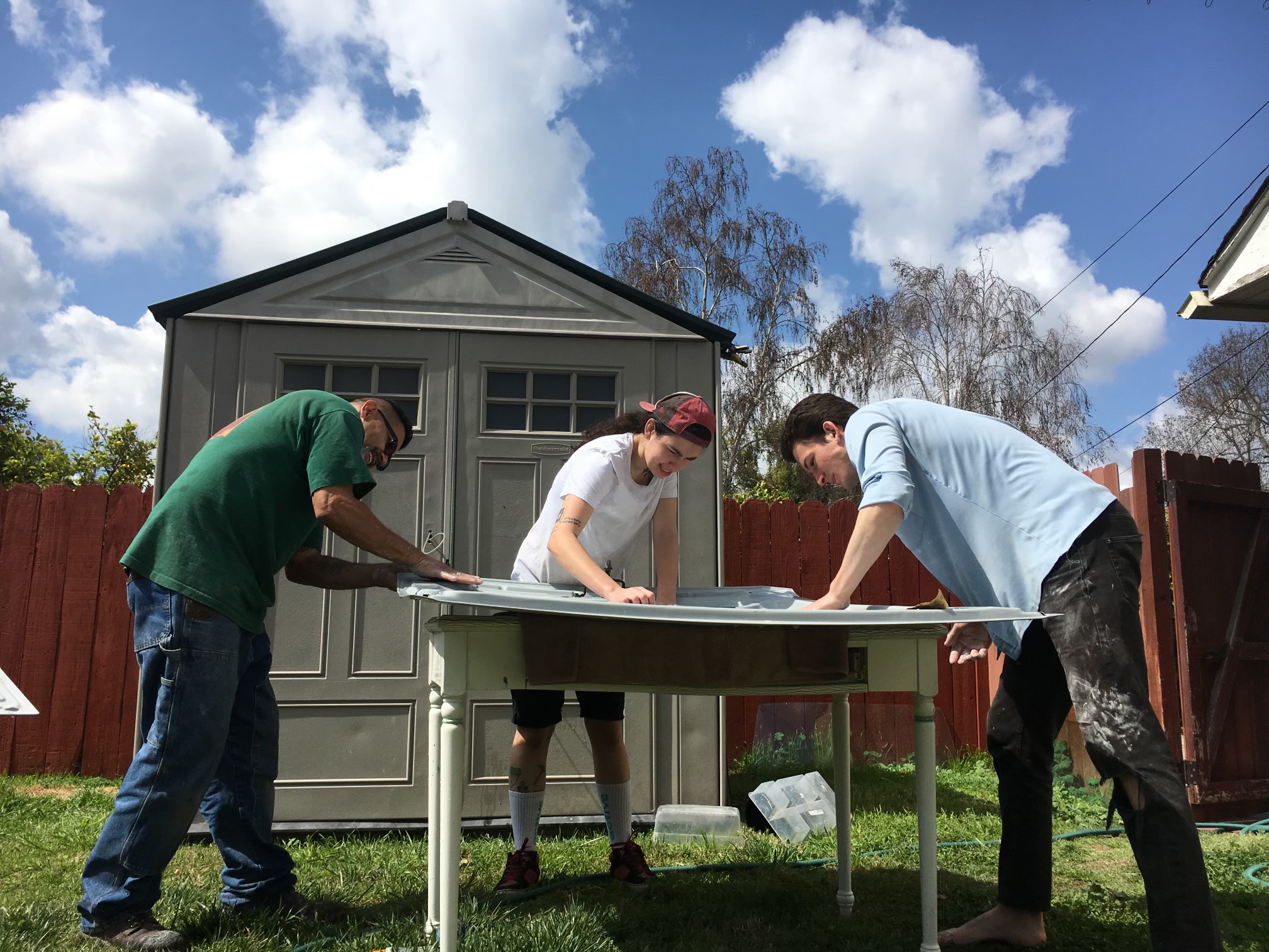 Uncle Johnny, Sage, and Koan sanding down the primer on the hood